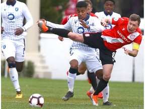 Cavalry FC Nik Ledgerwood (L) competes against FC Edmonton Marcus Velado-Tsegaye CPL soccer action between FC Edmonton and Cavalry FC in Calgary at Atco Field at Spruce Meadows on Saturday, May 18, 2019.