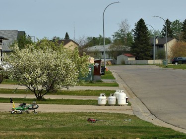 A childs bike on the front lawn of an empty residential street in High Level where about 4000 residents were evacuated from the Chuckegg Creek fire that is still approximately three kilometres from the town site, May 22, 2019.