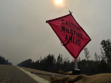 Smoke blocks the sun along Highway 35, about 15 km from High Level.