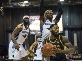 Ashton Smith of the Edmonton Stingers spins away from Myck Kabongo of the Guelph Nighthawks at the Edmonton Expo Centre on Friday, May 24, 2019.