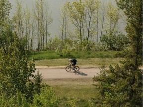 A cyclist rides in MacKinnon Ravine Park in Edmonton, on Monday, May 27, 2019. Photo by Ian Kucerak/Postmedia