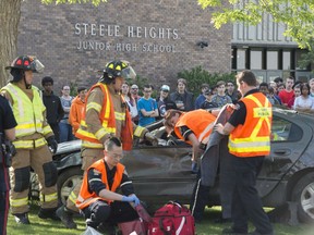 Steele Heights junior high students experienced first-hand the consequences of driving high and not wearing a seatbelt at a simulated crash scene on Tuesday, May 28. The students were unaware of the situation and  were brought out as first responders arrived at the scene to treat an injured actor and extricate them from the wreckage on May 28, 2019.