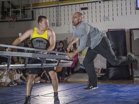 For the second year in a row, School Resource officer Const. Brian McCune and Owen Martin, a science teacher at Holy Trinity School  faced off  in a charitable  wrestling match in the school gym. This years charity is the Holy Trinity Breakfast Club. A program provides breakfast to kids when they come into school for the day on May 28, 2019. Photo by Shaughn Butts / Postmedia