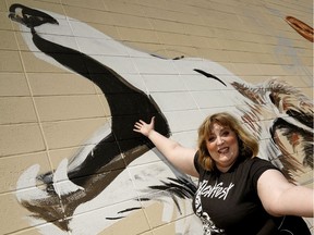 Nextfest 2019 festival director Ellen Chorley in front of a mural painted by artists Colleen Ulliac and Deanne Lee. The arts festival will take place May 30 to June 9.