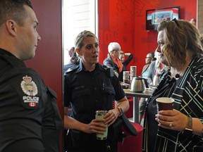 Ellie Sasseville (right, Kingsway District Association) talks with Edmonton Police Service members Sgt. Amber Maze (middle) and Cst. Mike Roblin (left) during the Coffee With the Cops community availability on May 31, 2019 at the the Kingsway McDonald's restaurant. (PHOTO BY LARRY WONG/POSTMEDIA) Story by Lisa Johnson
