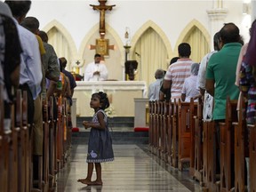 Sri Lankan Catholic devotees pray during a mass at the St. Theresa's church as the Catholic churches hold services again after the Easter attacks in Colombo on May 12, 2019. - Thousands of Catholics attended mass in Sri Lanka's capital Colombo on May 12 amid tight security to prevent a repeat of Easter bomb attacks that killed 258 people.