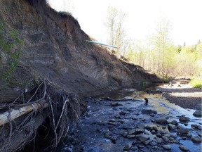 An exposed storm drainage line hangs over Mill Creek on May 21, 2019. Erosion is creating safety issues, according to nearby resident Allan Bolstad.