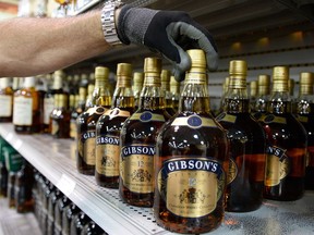 REGINA, SK: NOVEMBER 04, 2014 -- Al Clarke with the Saskatchewan Liquor and Gaming Authority (SLGA) stocking liquor shelves at the SLGA Quance Street location in Regina on Nov 04, 2014. (DON HEALY/Leader-Post) (Story by Bruce Johnstone) (BUSINESS) Don Healy, Regina Leader-Post