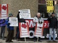A small group of protestors gather outside the Standing Senate Committee on Transport and Communications public hearing on oil tanker ban Bill C-48, at the Delta Hotel Centre Suites, in Edmonton Tuesday April 30, 2019.