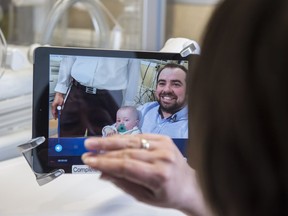 Casey Lane chats with her husband James Lane and their son Lorcan on Wednesday, May 1, 2019, at the Misericordia Community Hospital neonatal intensive care unit (NICU). iPad technology called NowICU is used to connect parents and babies who are not able to be together physically.