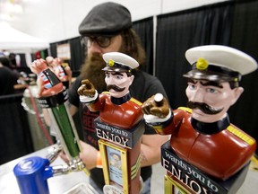 Kevin Moore pours a Blatchford Brown Ale at the Two Sergeants Brewing booth during the Edmonton Craft Beer Festival, at the Edmonton EXPO Centre Friday May 31, 2019. Photo by David Bloom