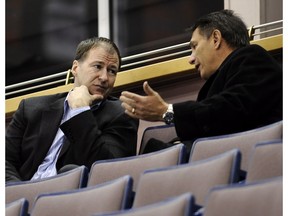 Then-Edmonton Oilers general manager Kevin Lowe speaks with then-Detroit Red Wings GM Ken Holland in this file photo from Feb. 25, 2008, in Edmonton.