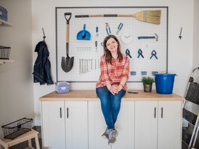 Founder of the DIY Mommy blog, Christina Dennis, showing off her DIY work bench and framed pegboard in Brookfield Residential's Robson show home in Paisley.