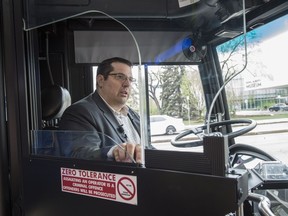 Eddie Robar, the branch manager of Edmonton Transit Service, demonstrates the first operator retractable shields for ETS buses, which were installed in May 2019. Starting Friday, Nov. 13, 2020, Edmonton transit riders who feel unsafe will be able to text the control centre directly for help.