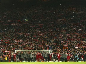 Liverpool players celebrate their victory with supporters after wining the Champions League semifinal, second leg, soccer match between Liverpool and FC Barcelona at the Anfield stadium in Liverpool, England, Tuesday, May 7, 2019.