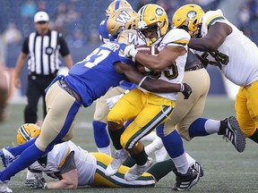 Winnipeg Blue Bombers' Brandon Alexander (37) tackles Edmonton Eskimos' Alex Taylor (33) during the first half of CFL action in Winnipeg Friday, May 31, 2019.