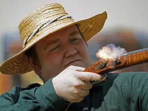Neil Cramer, a member of the Edmonton House Brigade, fires his antique flintlock muzzle loading musket at Fort Edmonton Park on Saturday May 25, 2019, where the park that leads you through four historical periods between 1846 and 1929, held its 50th Homecoming Anniversary at the park's Blatchford Air Hanger.
