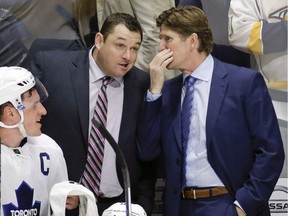 Toronto Maple Leafs head coach Mike Babcock, right, talks with assistant coach D. J. Smith during a shootout against the Nashville Predators at an NHL hockey game Thursday, Nov. 12, 2015, in Nashville, Tenn. Former Toronto Maple Leafs assistant coach D.J. Smith is the new head coach of the Ottawa Senators.The Senators announced the hiring today. Smith replaces interim head coach Marc Crawford, who also interviewed for the position.