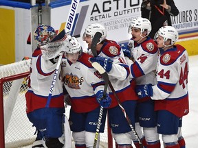 Edmonton Oil Kings congratulate goalie Todd Scott after defeating the Medicine Hat Tigers in game five 5-4 during WHL first round playoff action at Rogers Place in Edmonton, March 29, 2019.