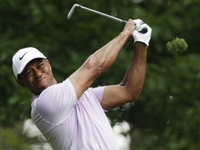 Tiger Woods hits from the fourth tee during the third round for the Masters golf tournament in Augusta, Ga., on April 13, 2019.