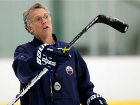Edmonton Oilers head Coach Craig MacTavish uses his stick as a pointer as he gives directions during practice at Millenium Place in this file photo from Oct. 4, 2006.