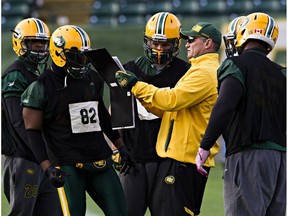 Linebackers coach Phillip Lolley runs plays during Edmonton Eskimos practice at Commonwealth Stadium in this file photo from Nov. 21, 2014. This season, he is back to co-ordinate the Eskimos defence.