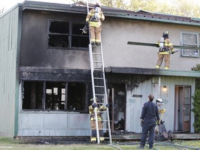 Firefighters respond to a structure fire at a Holyrood townhome in  central Edmonton Friday, May 17, 2019.