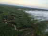 Airtankers lay retardant to help slow the growth of the fire southwest of High Level.