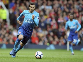 In this Sunday, April 29, 2018 file photo, Arsenal's Henrikh Mkhitaryan runs with the ball during their English Premier League soccer match against Manchester United at the Old Trafford stadium in Manchester, England. Arsenal's Granit Xhaka and Sokratis Papastathopoulos say they want to win the Europa League title for their teammate Henrikh Mkhitaryan, who is missing the final on Wednesday, May 29, 2019 for political reasons. Xhaka says "of course we're disappointed he's not here," adding that "we want to give him a trophy too."