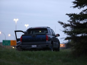 Edmonton police were called to investigate a body and smashed pickup truck at the scene of a suspected homicide Wednesday, May 15, 2019, on the city's west end at 184 Street near the Yellowhead Trail. Ian Kucerak/Postmedia