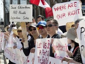 Members of the Chinese community  and downtown residents protest the proposed concentration of safe injection sites in their neighbourhoods, outside City Hall in Edmonton Sat. May 6, 2017.