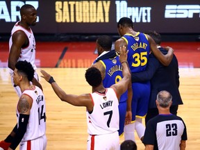 TORONTO, ONTARIO - JUNE 10: Kevin Durant #35 of the Golden State Warriors is assisted off the court after sustaining an injury in the first half against the Toronto Raptors during Game Five of the 2019 NBA Finals at Scotiabank Arena on June 10, 2019 in Toronto, Canada.