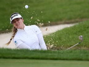 Hannah Green of Australia hits from a green side bunker on the 18th green during the final round of the KPMG PGA Championship at Hazeltine National Golf Club on June 23, 2019, in Chaska, Minn.