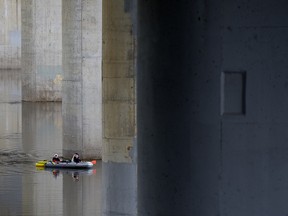 Boaters float under the Quesnell Bridge, in Edmonton Wednesday June 5, 2019. Photo by David Bloom