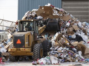 An equipment operator uses a front end loader outside the recycling building at Edmonton Waste Management Centre in Edmonton, Alberta on Wednesday, December 27, 2017.