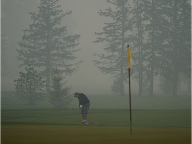 A golfer hits a ball at the Derrick Golf Club on Thursday May 30, 2019. An air quality advisory is in effect for the Edmonton region as smoke from wildfires in northern Alberta is causing poor air quality and reduced visibility in the region.