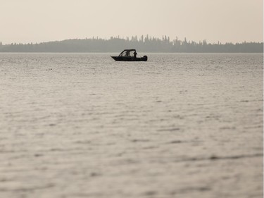 Boaters fish off Devonshire Beach during a wildfire evacuation alert continues in the town of Slave Lake, on Saturday, June 1, 2019.