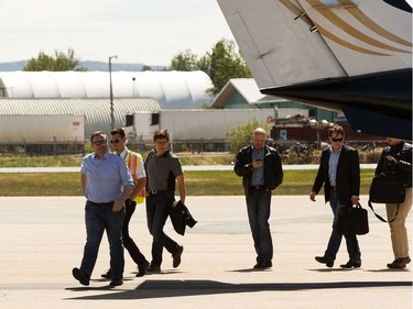 Premier Jason Kenney (in blue) arrives at Slave Lake Airport during a tour of fire effected areas on Sunday, June 2, 2019. Photo by Ian Kucerak/Postmedia