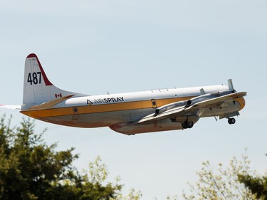 A Lockheed L-188 Electra air tanker takes off as a wildfire evacation alert continues in the town of Slave Lake, on Sunday, June 2, 2019.