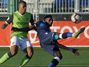 FC Edmonton's Jeannot Esua (right) takes control of the ball in front of York9 FC's Ryan Telfer (left) during Canadian Premier League soccer game action in Edmonton on Wednesday June 12, 2019.