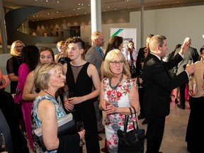 People mingle during the MET Gala at the Royal Alberta Museum on Saturday, June 8