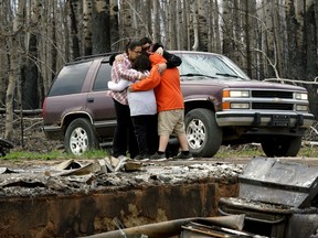 Paddle Prairie Metis Settlement residents Angie and Ronnie Cardinal and their children are overcome with grief after seeing the remains of their home on Thursday June 20, 2019. All residents of the community were evacuated four weeks ago when a wildfire swept through Alberta's largest Metis settlement and destroyed at least fifteen homes. None of the residents had insurance for their homes. The settlement is located 660 kilometres north of Edmonton, Alberta.