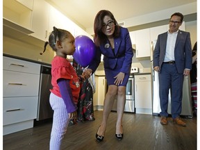 Josephine Pon (Alberta Minister of Seniors and Housing) meets Ikhlas Mohamed Ali (2-years-old) at the grand opening of Parkdale ONE, a new affordable housing facility in Edmonton, on Wednesday June 26, 2019. Greg Dewling (right, CEO, Capital Region Housing) was having a look at one of the residential units with the Minister.