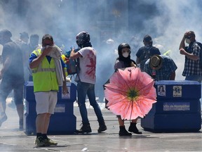 Protesters take part in an anti-government demonstration called by the Yellow Vests (Gilets jaunes) movement in Montpellier, southern France, on June 8, 2019. - Demonstrators hit French city streets again on June 8, for a 30th consecutive week of nationwide protest against the French President's policies and his top-down style of governing, high cost of living, government tax reforms and for more "social and economic justice."