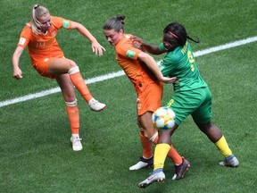 Netherlands midfielder Jackie Groenen, left, kicks the ball in front of Netherlands' midfielder Sherida Spitse (C) and Cameroon's midfielder Raissa Feudjio during the France 2019 Women's World Cup Group E football match between the Netherlands and Cameroon, on June 15, 2019, at the Hainaut Stadium in Valenciennes, northern France.