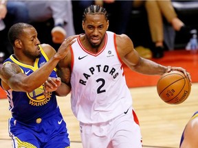 Toronto Raptors forward Kawhi Leonard (2) dribbles against Golden State Warriors guard Andre Iguodala (9) during the third quarter in Game 5 of the 2019 NBA Finals.