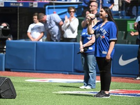 CP-Web.  Kiya Bruno sings the Canadian national anthem before first inning MLB baseball action between the Toronto Blue Jays and the Kansas City Royals, in Toronto, Saturday, June 29, 2019.