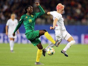 Marlyse Ngo Ndoumbouk of Cameroon battles for possession with Sophie Schmidt of Canada during the 2019 FIFA Women's World Cup France group E match between Canada and Cameroon at Stade de la Mosson on June 10, 2019 in Montpellier, France.