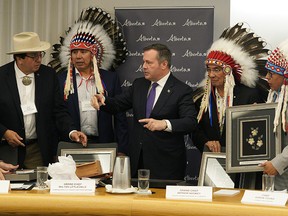 Premier Jason Kenney exchanges gifts with Chief Roy Fox of the Blood Tribe in Treaty 7, left, Grand Chief Arthur Noskey of Treaty 8, Grand Chief Wilton Littlechild of Treaty 6 and Chief Aaron Young of the Chiniki First Nation in Treaty 7 after a meeting at Government House in Edmonton on Monday, June 10, 2019.