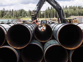 Pipe for the Trans Mountain pipeline is unloaded in Edson, Alta. on Tuesday, June 18, 2019.